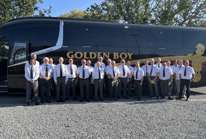 Our men's team outside their tour bus